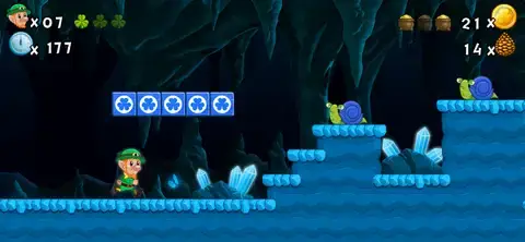 Character exploring icy cave with snails and ice blocks in a platform game.